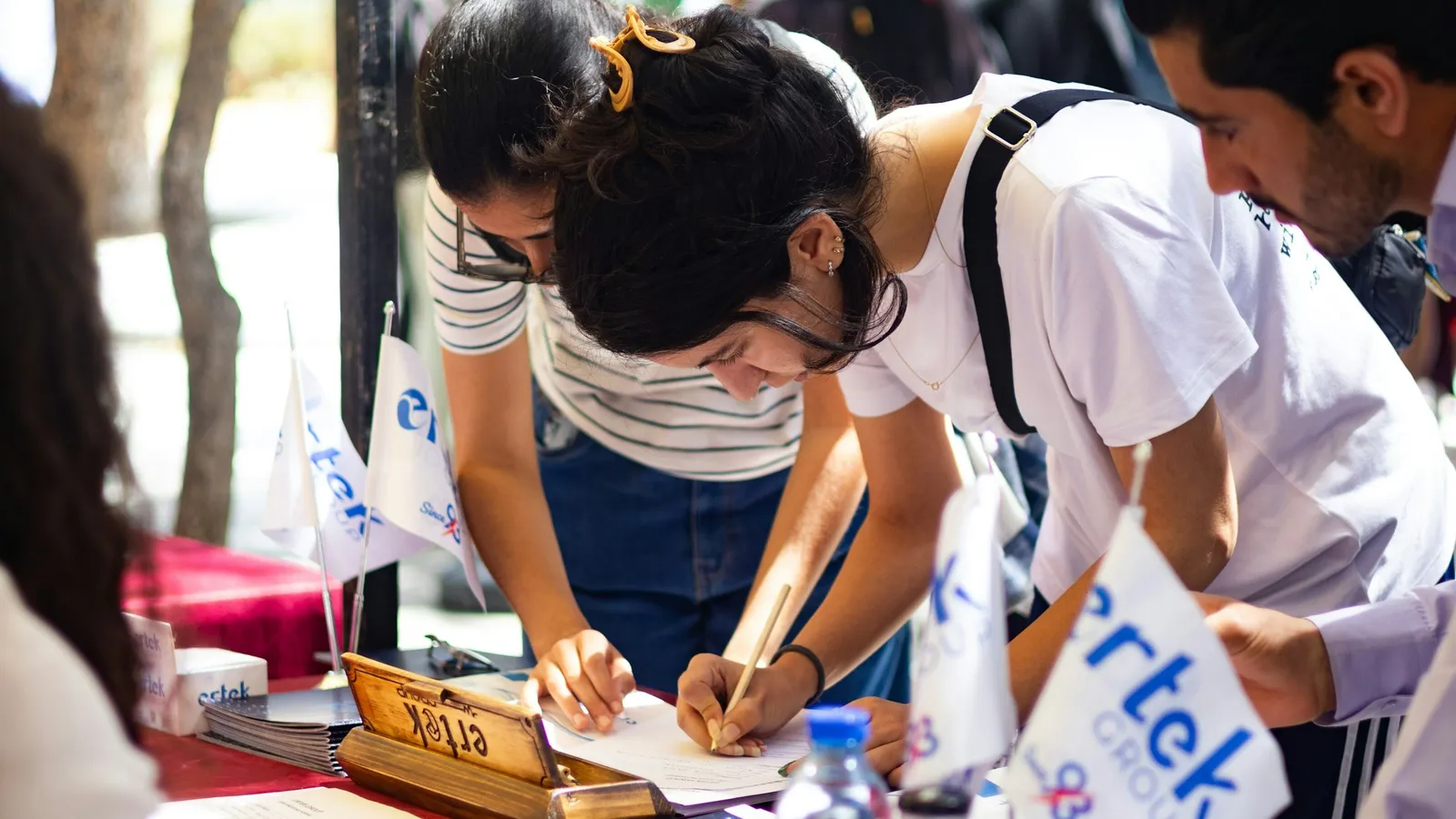 Students filling in forms at a registration desk