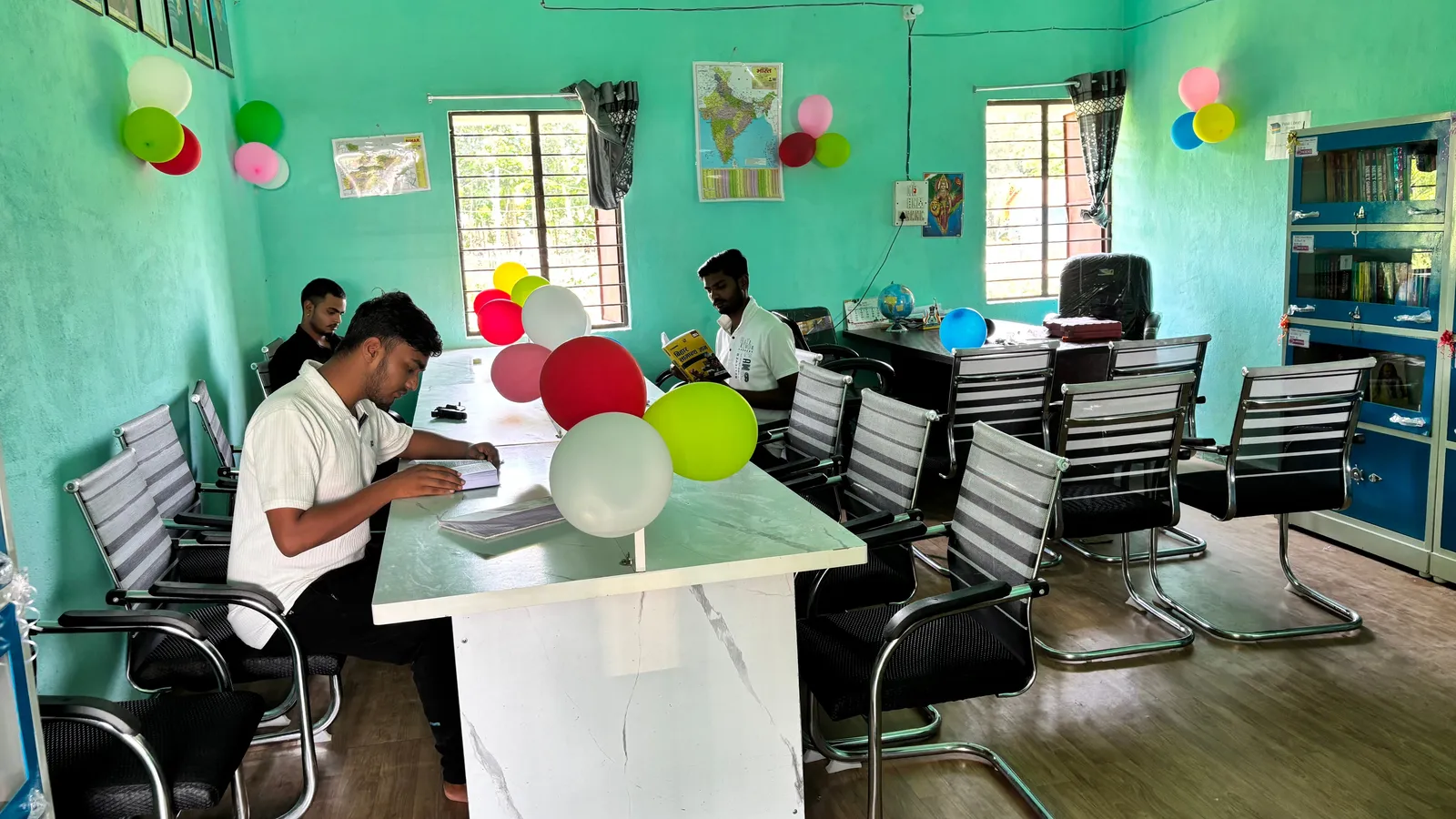 Students reading at a long table in a public library in Bihar, India