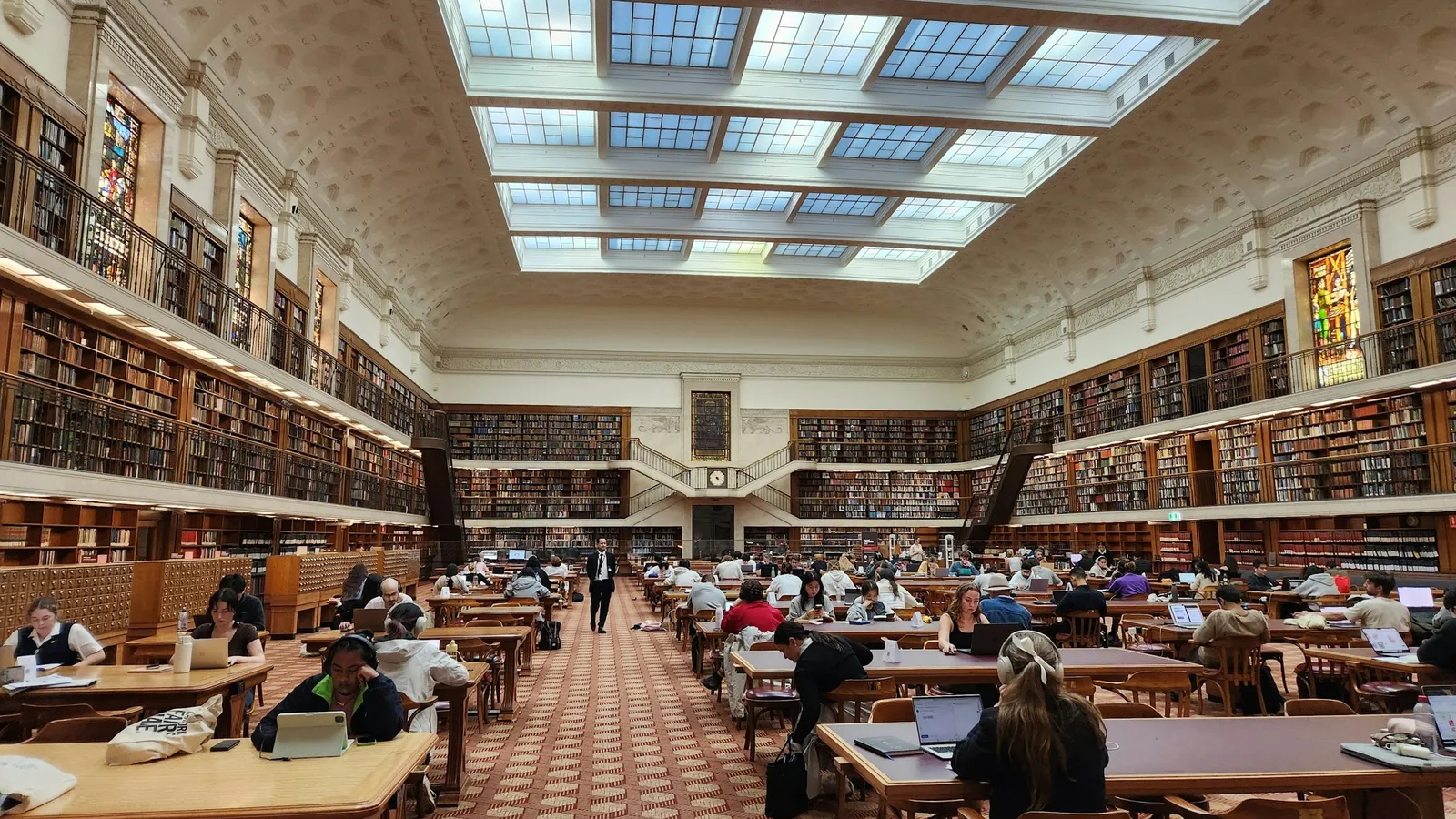 Students studying in a large university library