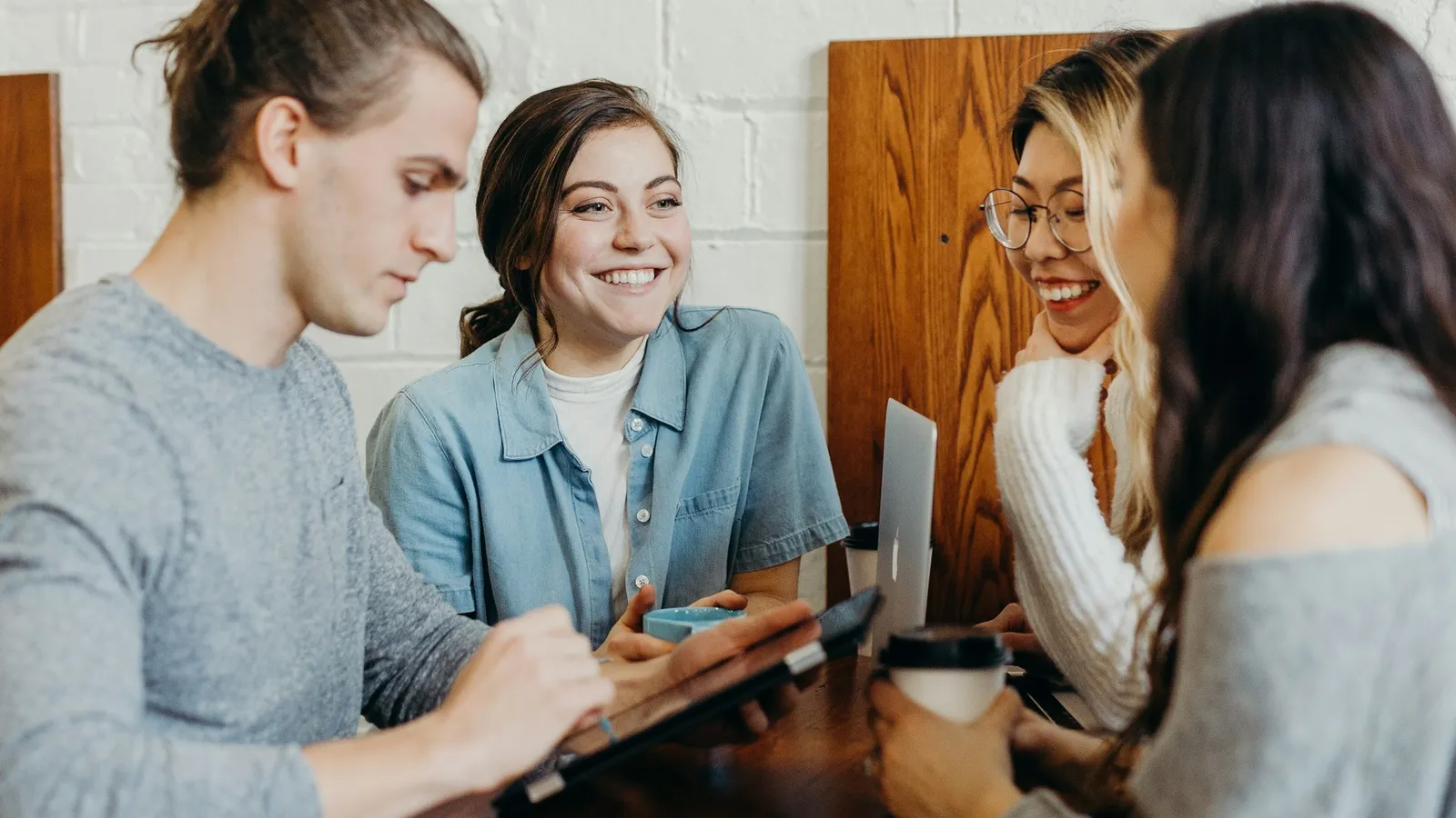 Students talking and working together at a table
