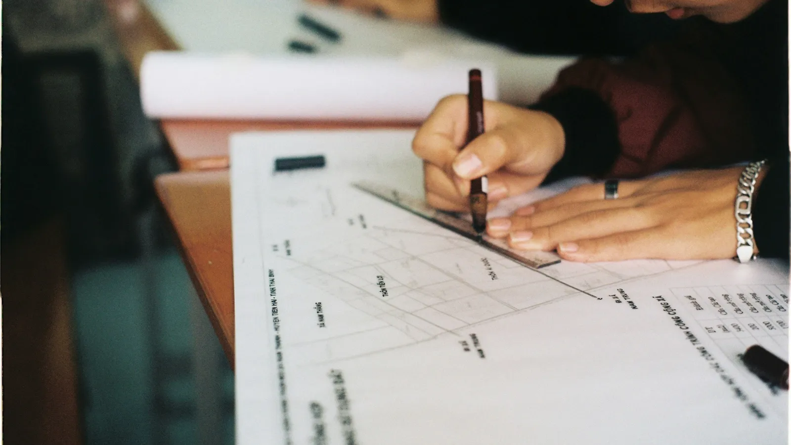 Students writing maths on worksheets at a desk