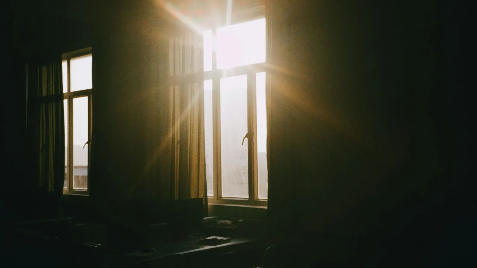 Sunlight streaming through a window into a dark room