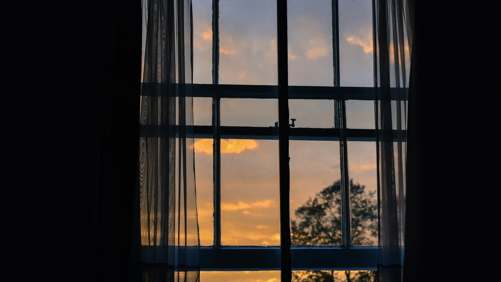 Sunset light shining through old window panes