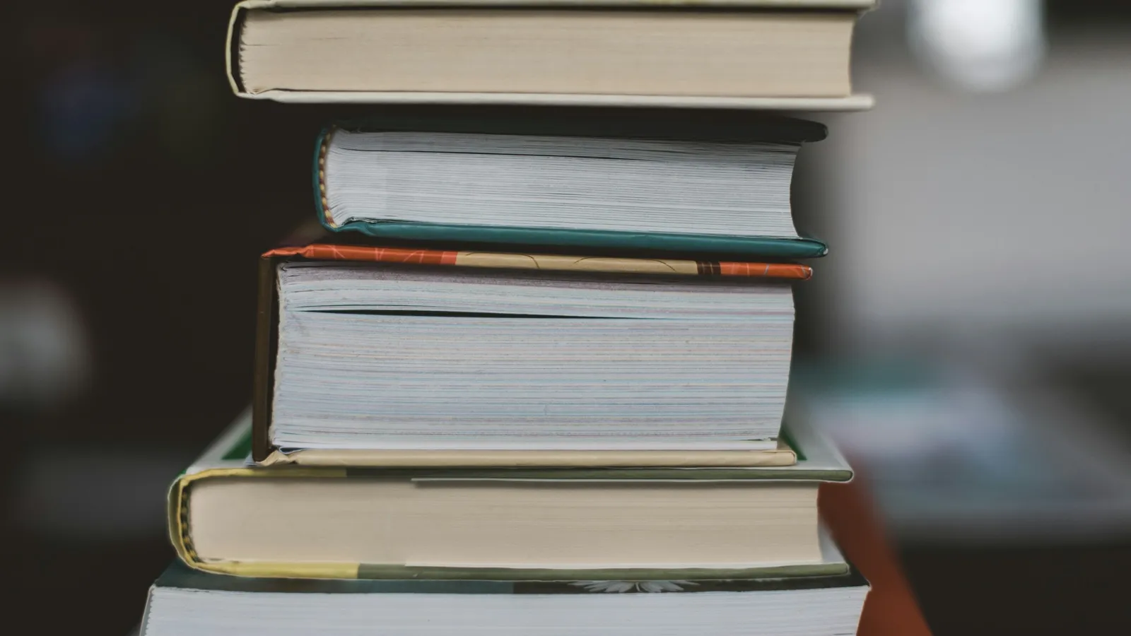 Tall stack of books on a desk