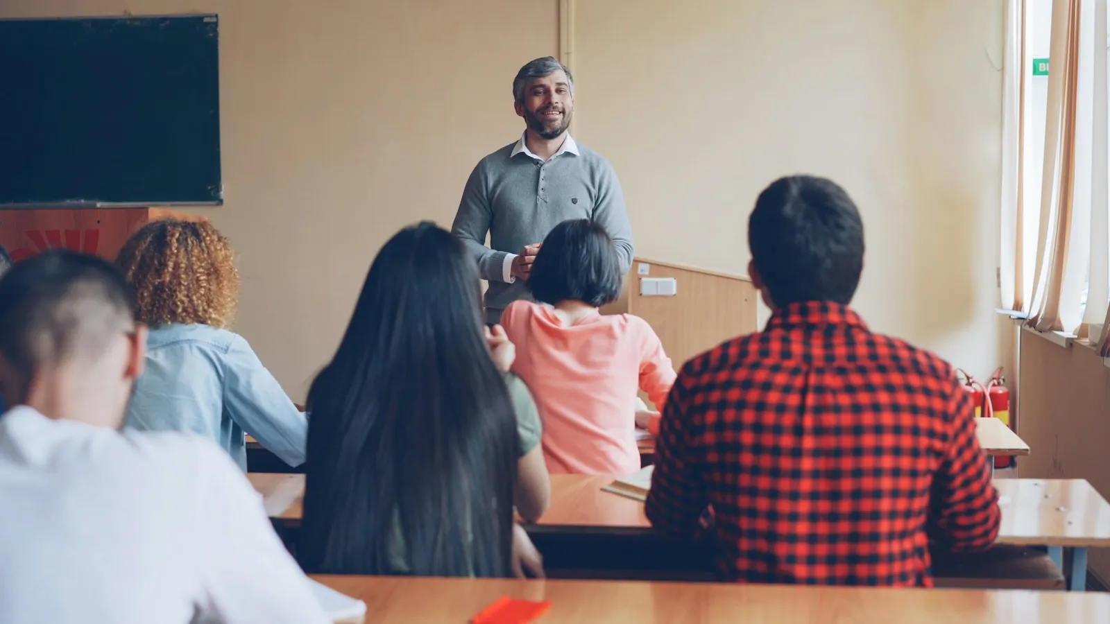 Teacher speaking to a group of adults in a classroom