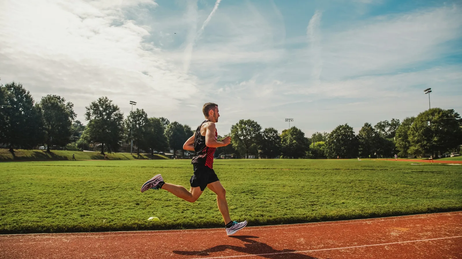 Teenager running on a sports field