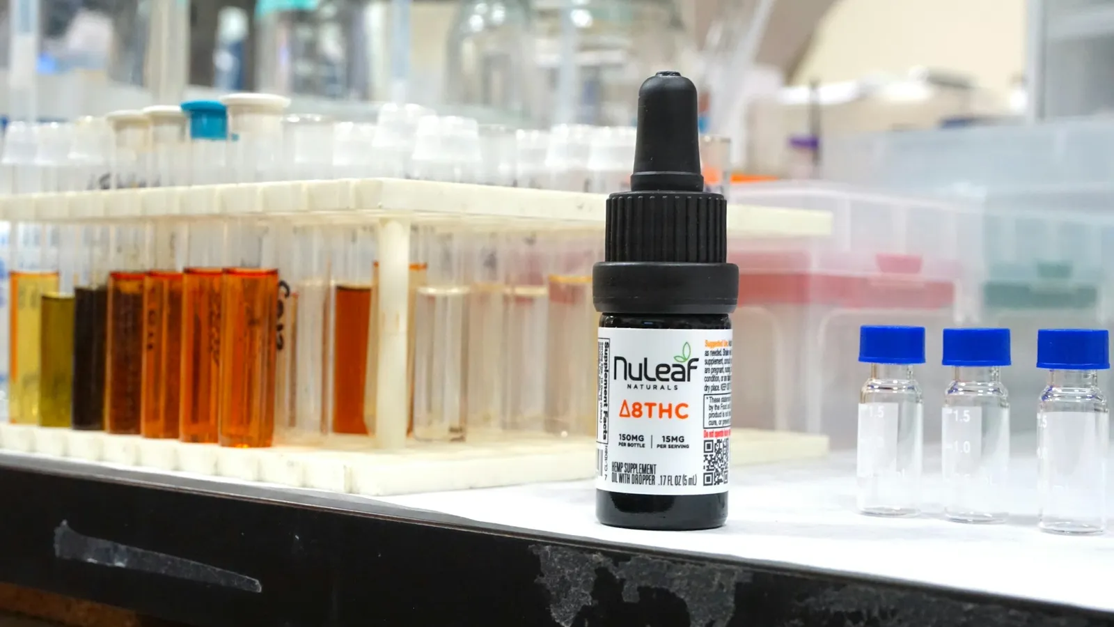 Test tubes of coloured solutions beside a dropper bottle