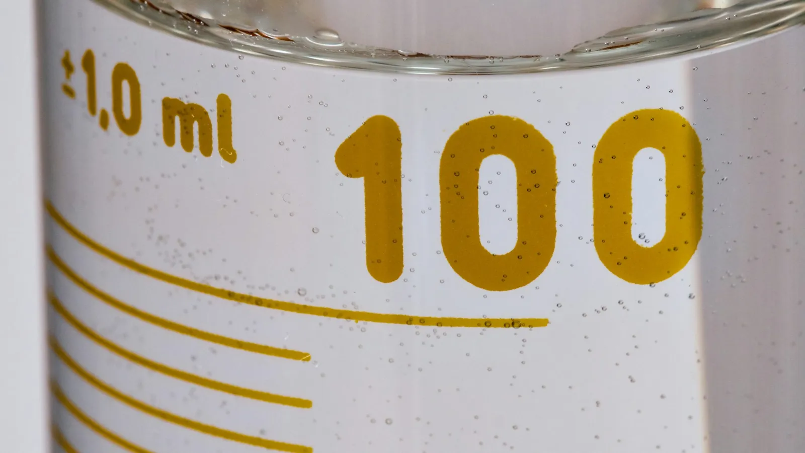 The 100 ml marking on a glass measuring cylinder