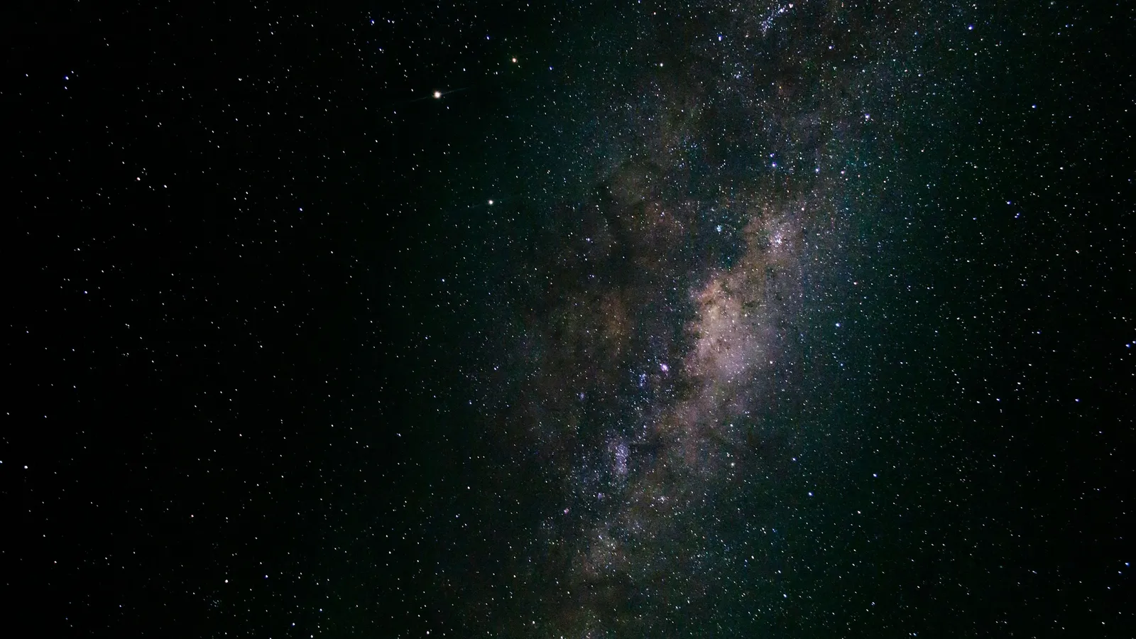 The band of the Milky Way across a dark starry sky