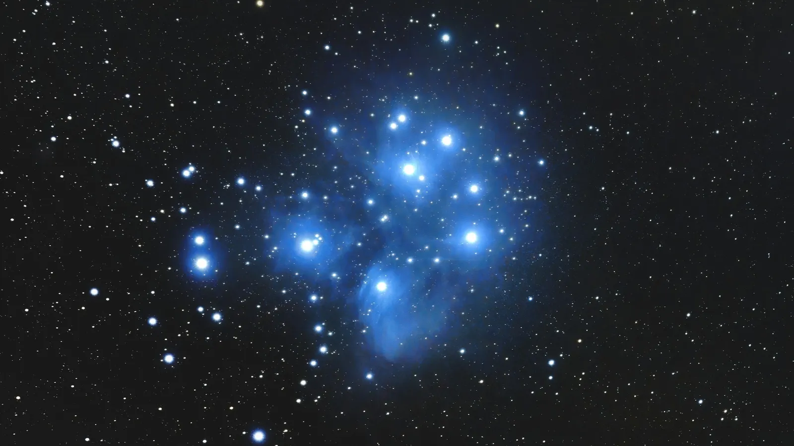 The bright blue stars of the Pleiades cluster