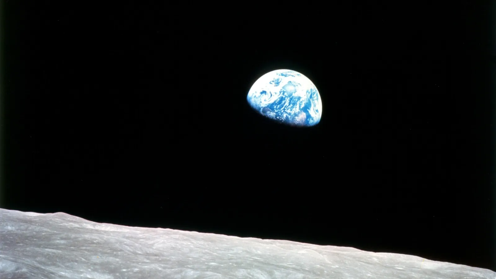 The Earth rising above the horizon of the Moon