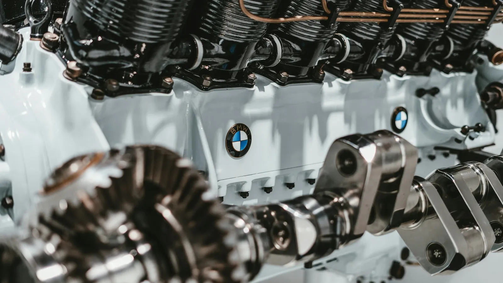 The exposed cylinder head and parts of a car engine