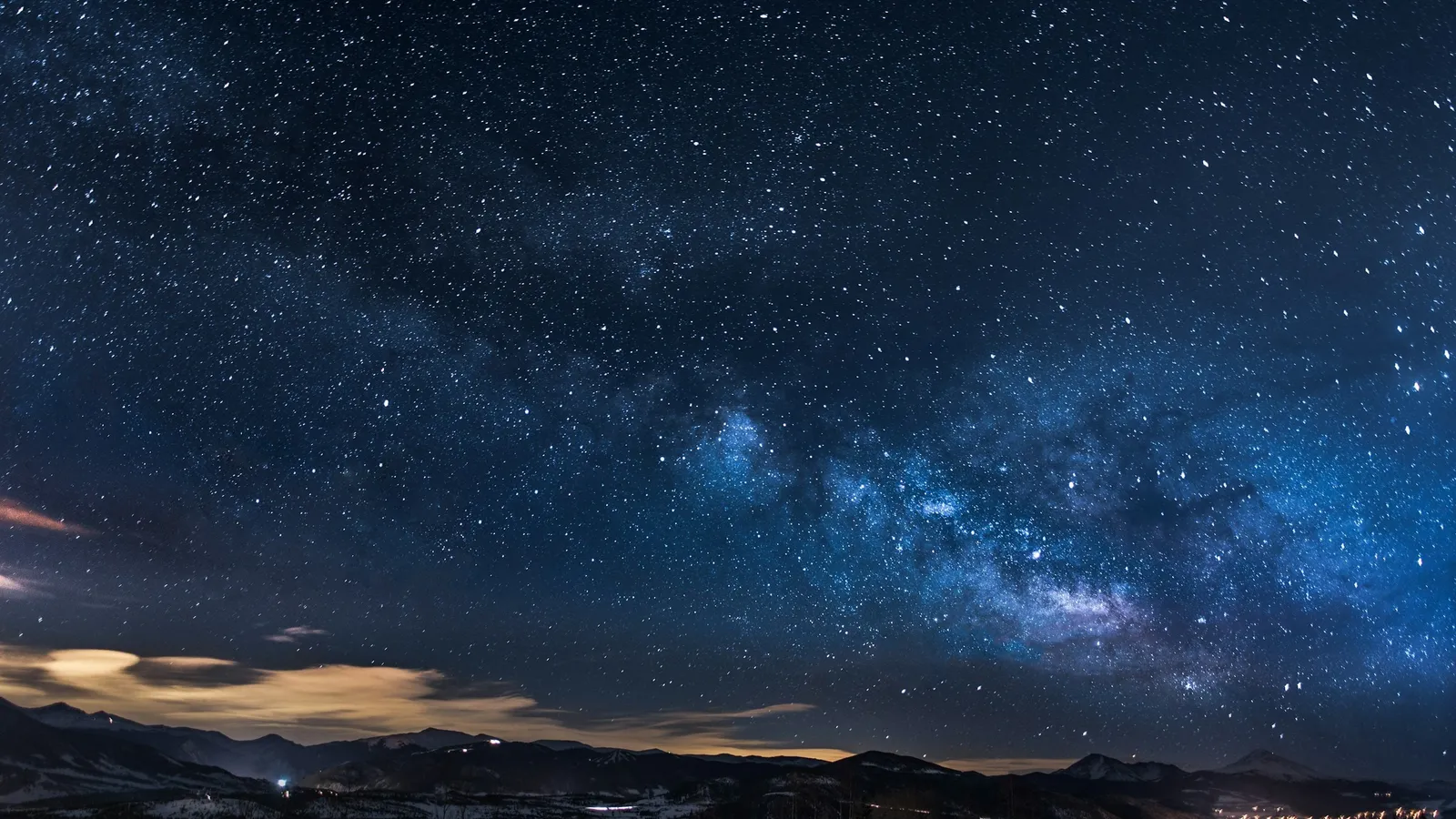 The Milky Way rising over a dark landscape