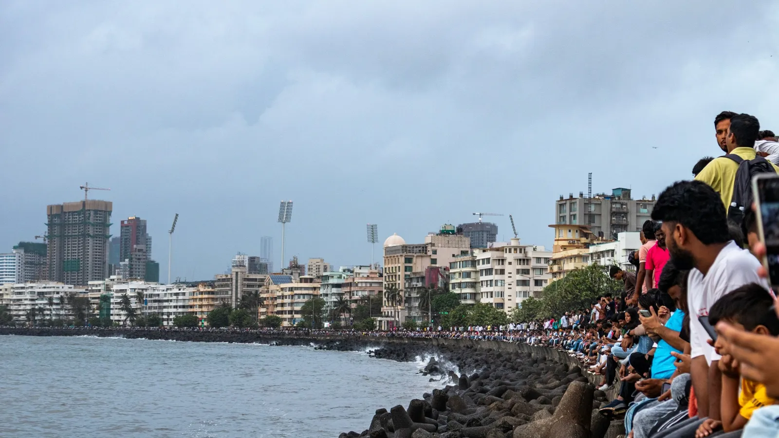 The Mumbai seafront with people along the promenade
