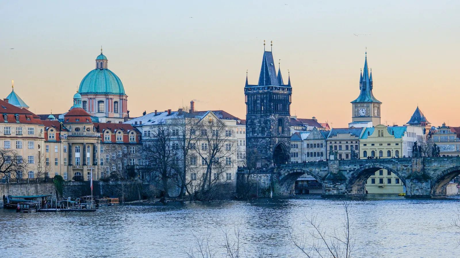 The old town of Prague beside the river at dusk