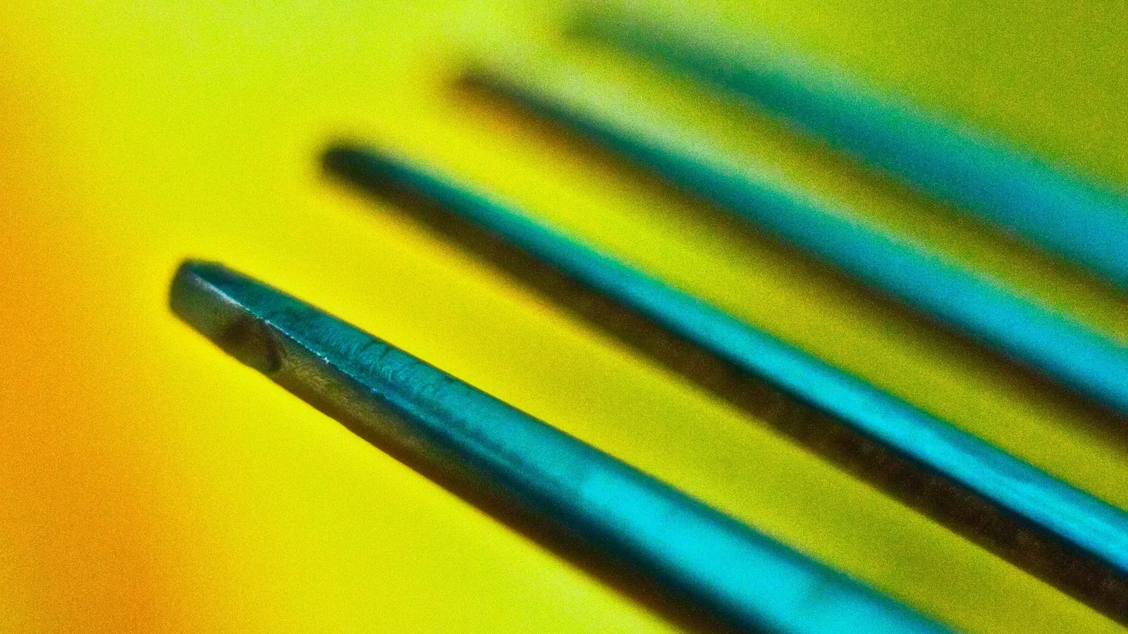 The prongs of a tuning fork on a bright background