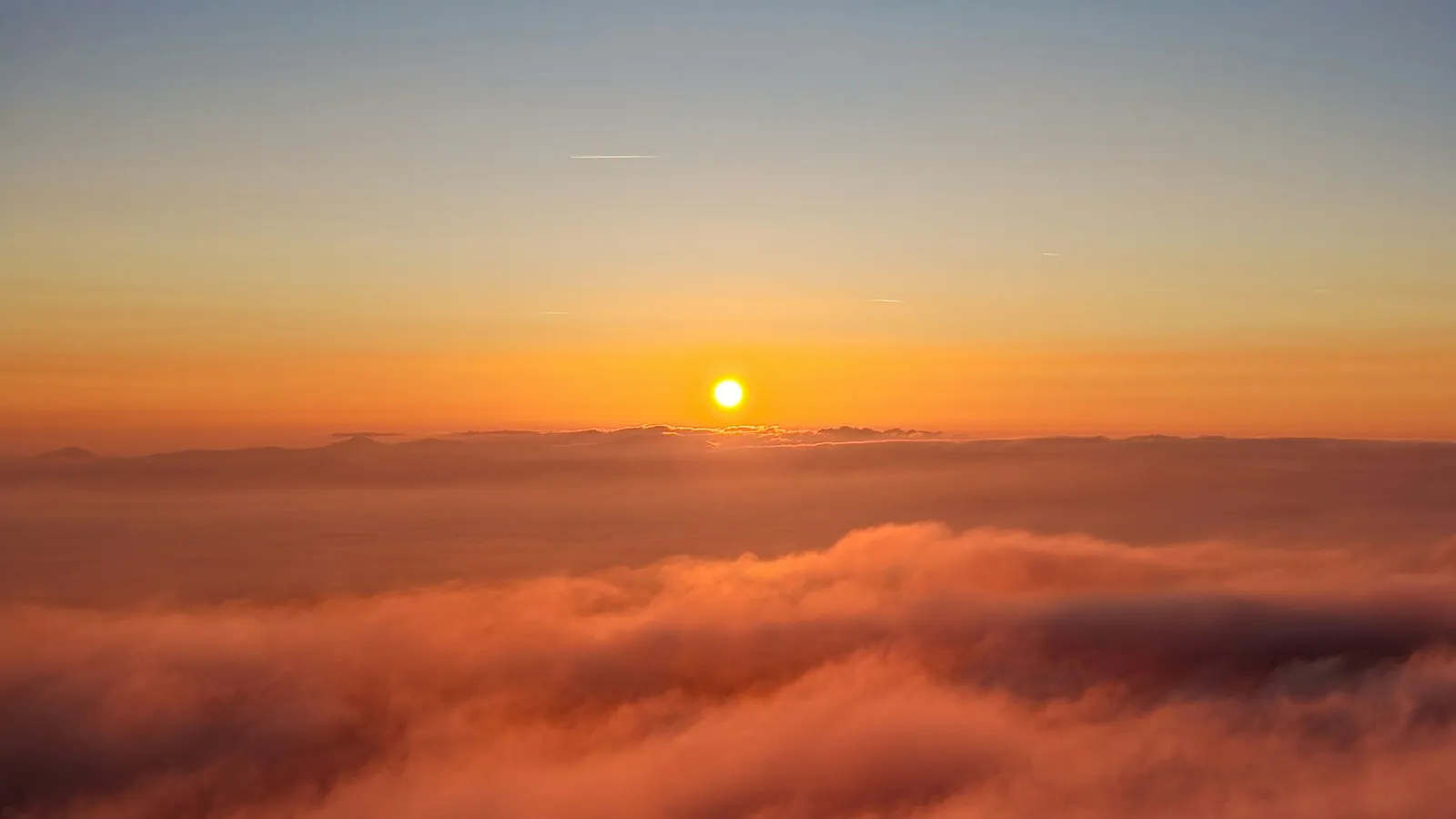 The Sun rising above a sea of clouds