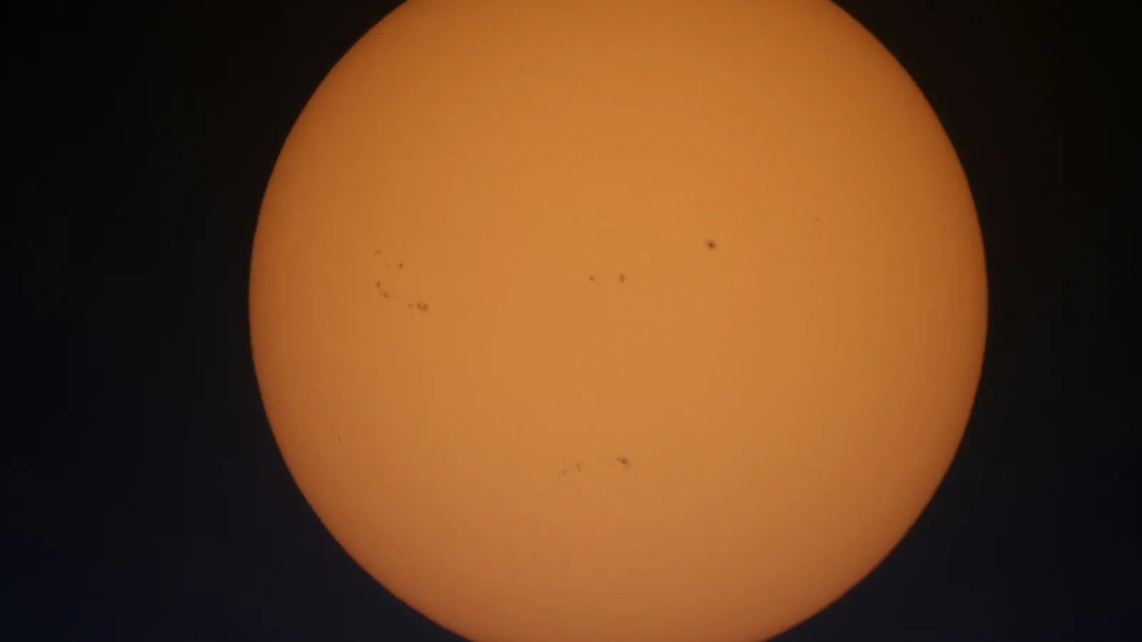 The Sun's disc dotted with dark sunspots