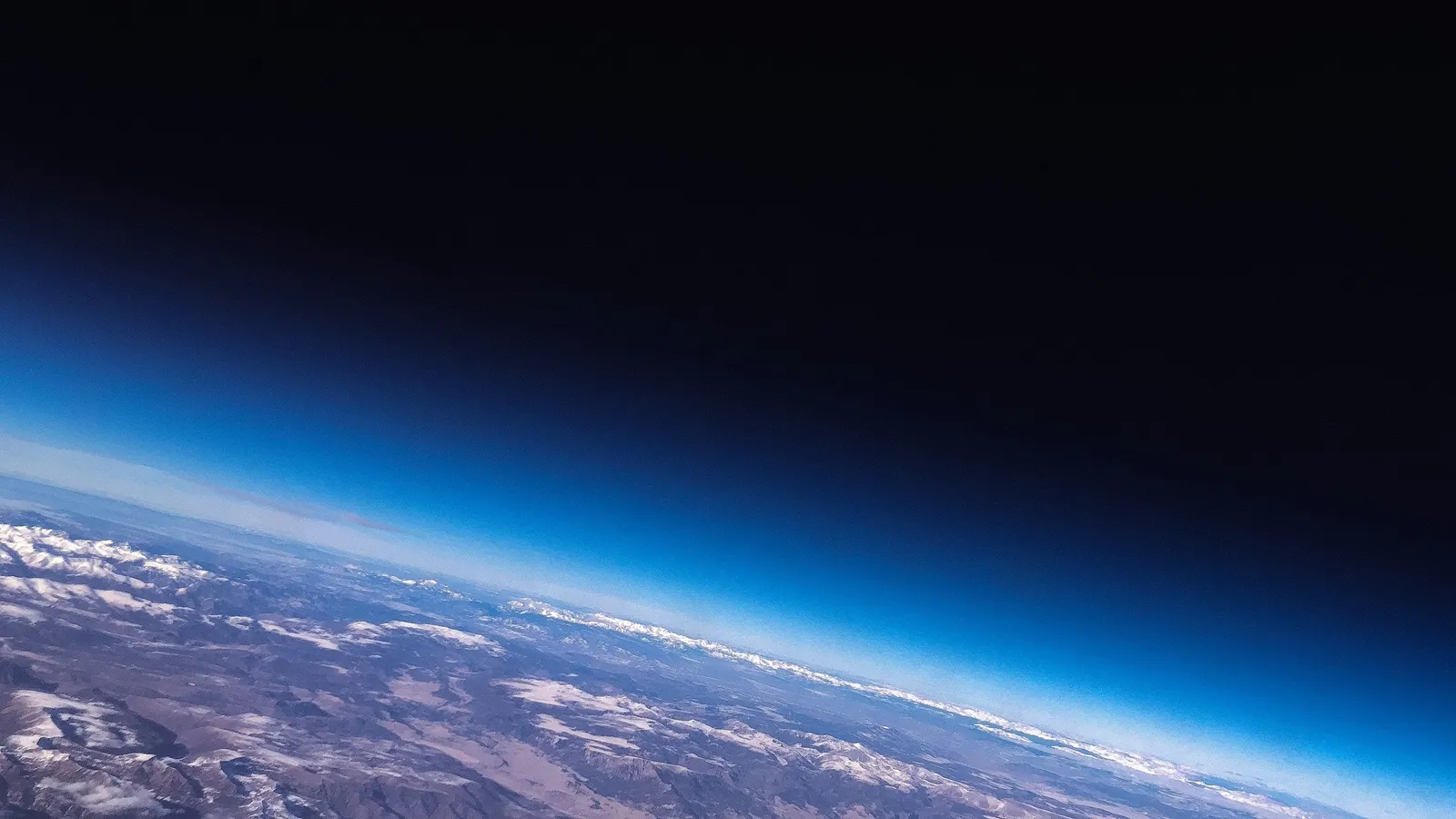 The thin blue layer of the atmosphere along the curve of the Earth