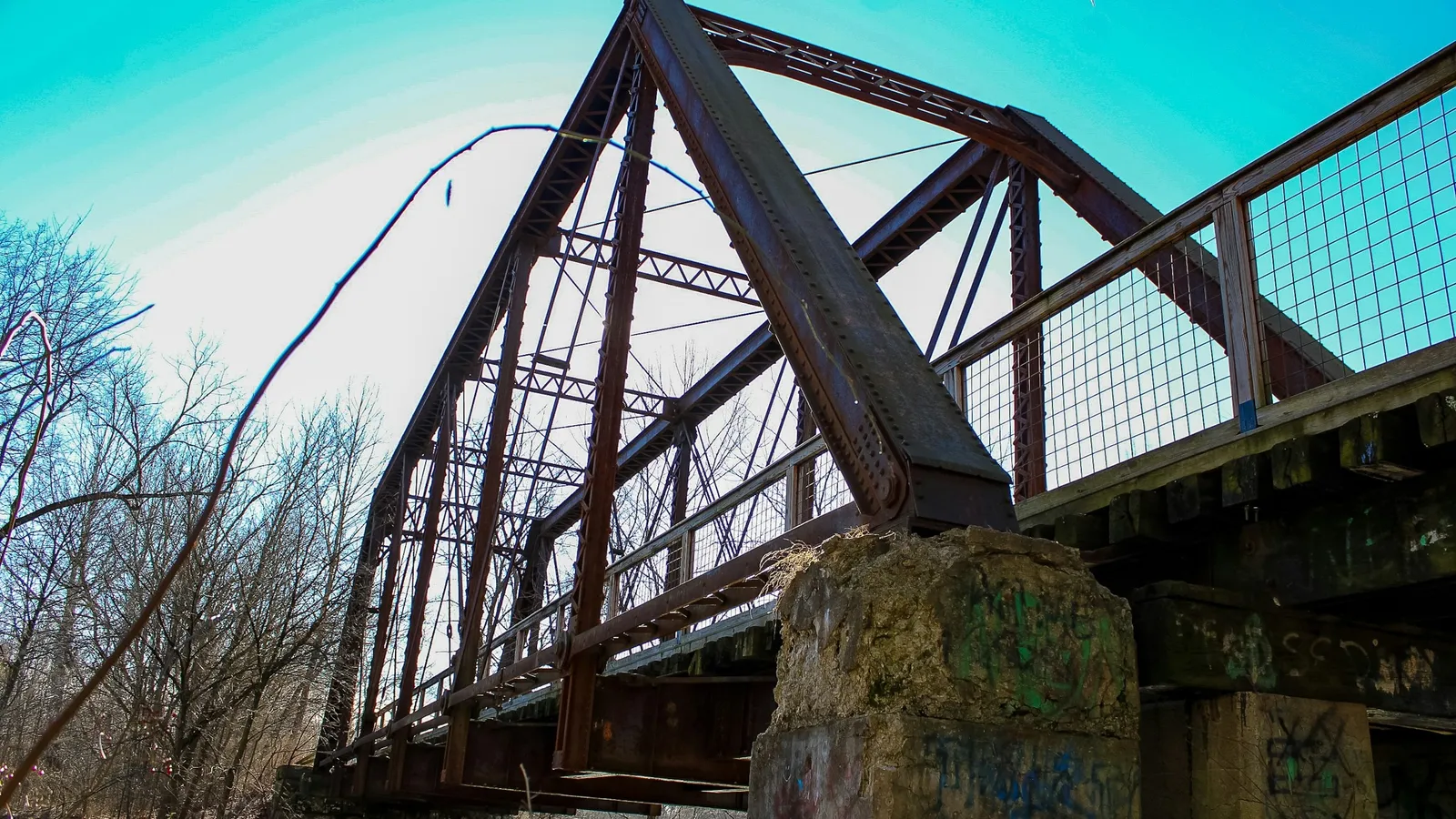 The triangular steel trusses of an old bridge