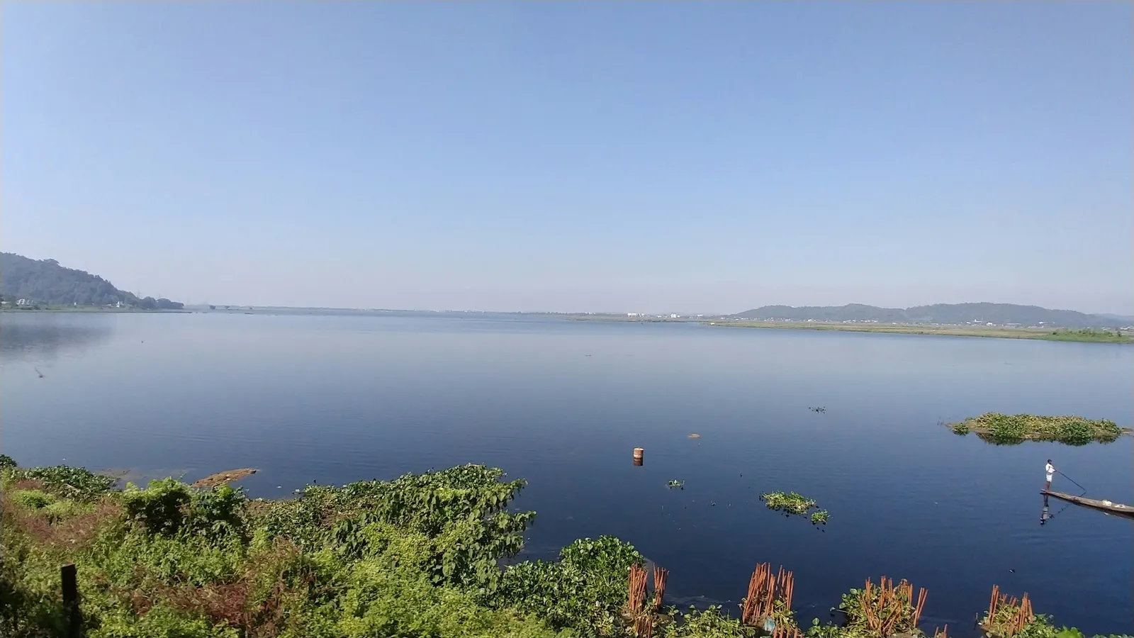 The wide Brahmaputra river under a blue sky