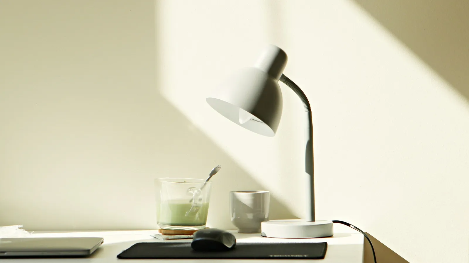 Tidy desk with a lamp in soft daylight