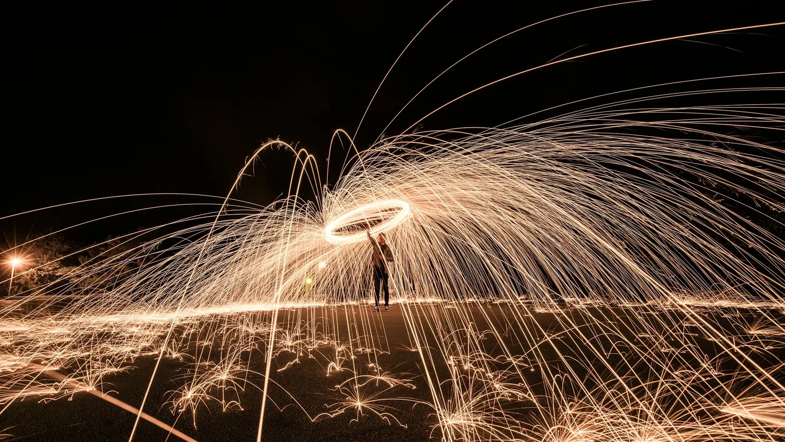 Trails of sparks spiralling in the dark