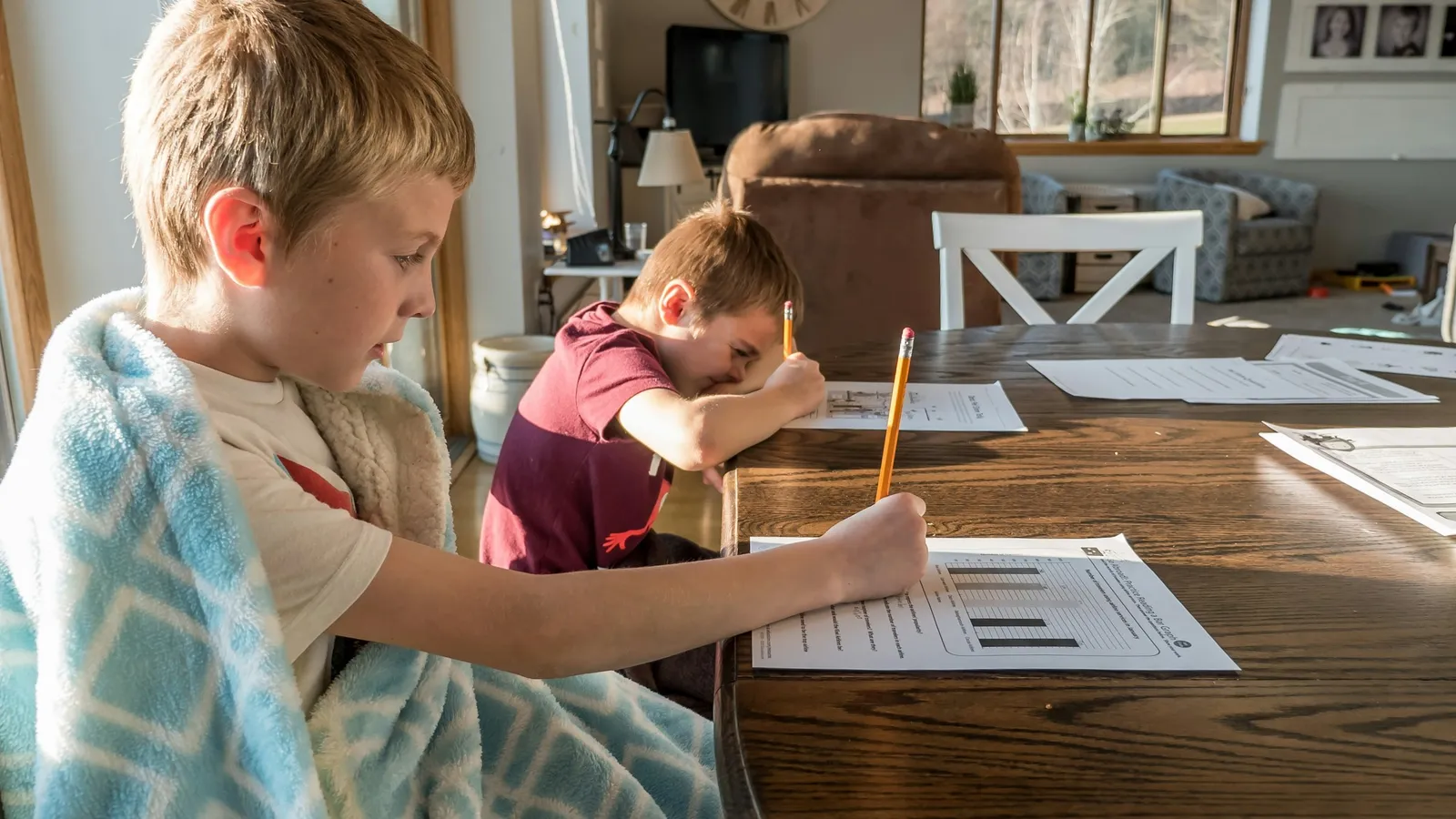 Two children doing homework at a table