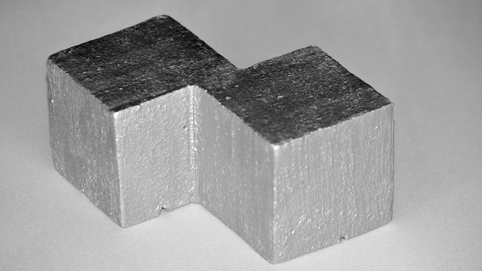 Two cut blocks of shiny grey metal