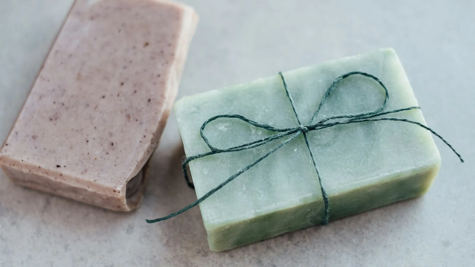 Two handmade bars of soap tied with string