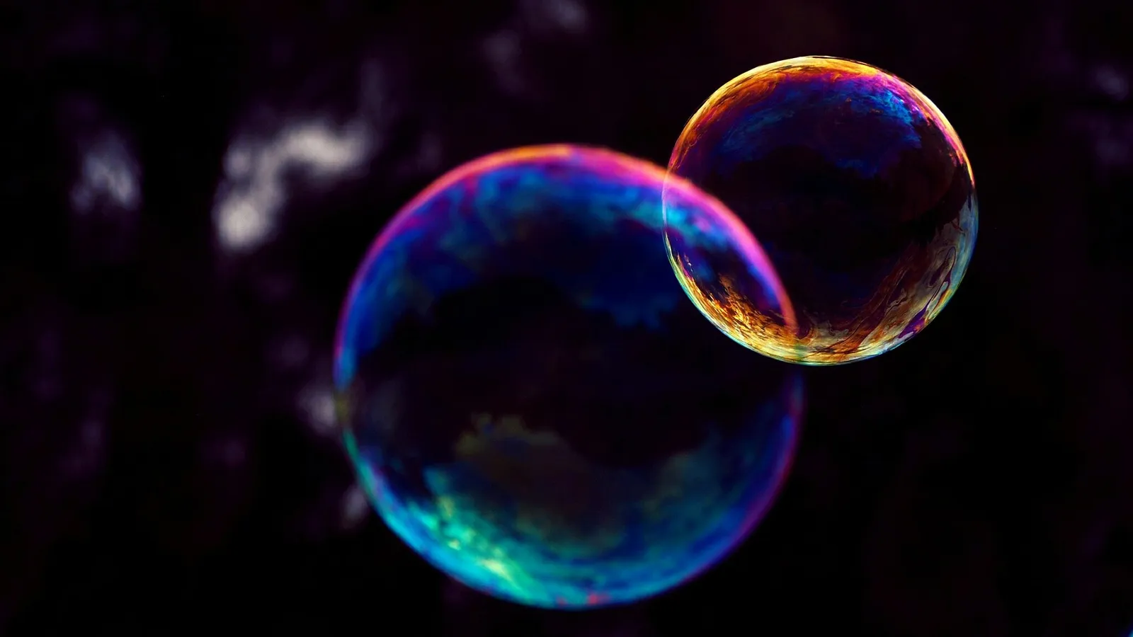 Two soap bubbles showing rainbow interference colours