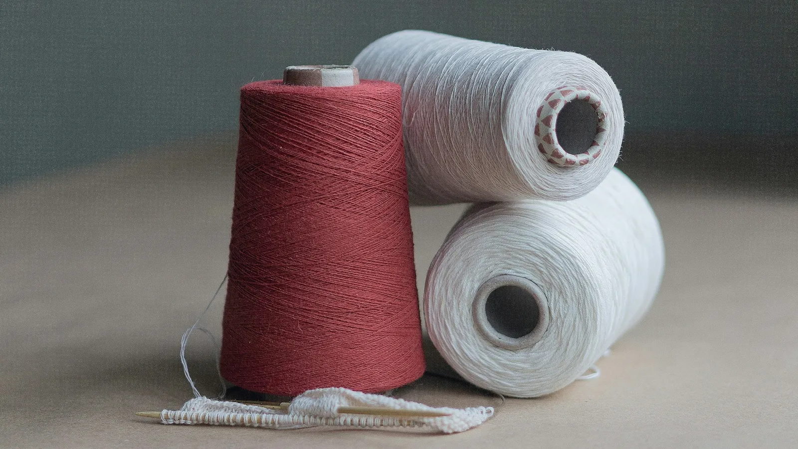 Two spools of thread on a table