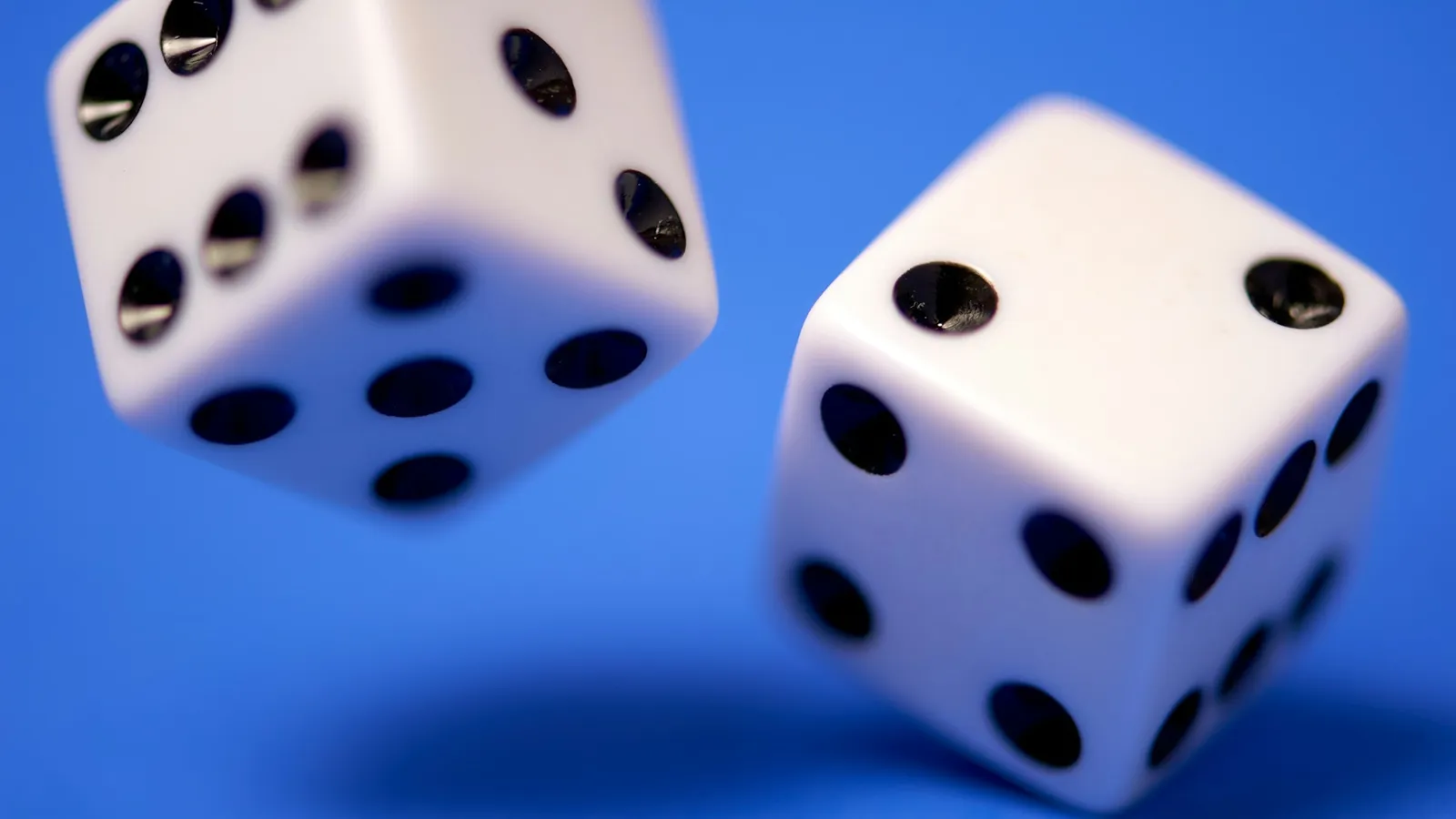 Two white dice on a blue background