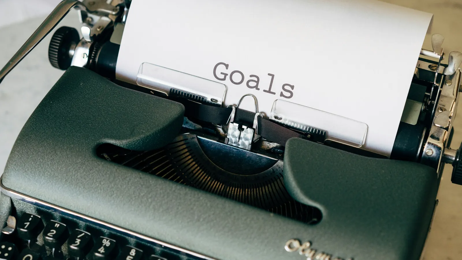 Typewriter with a page titled Goals