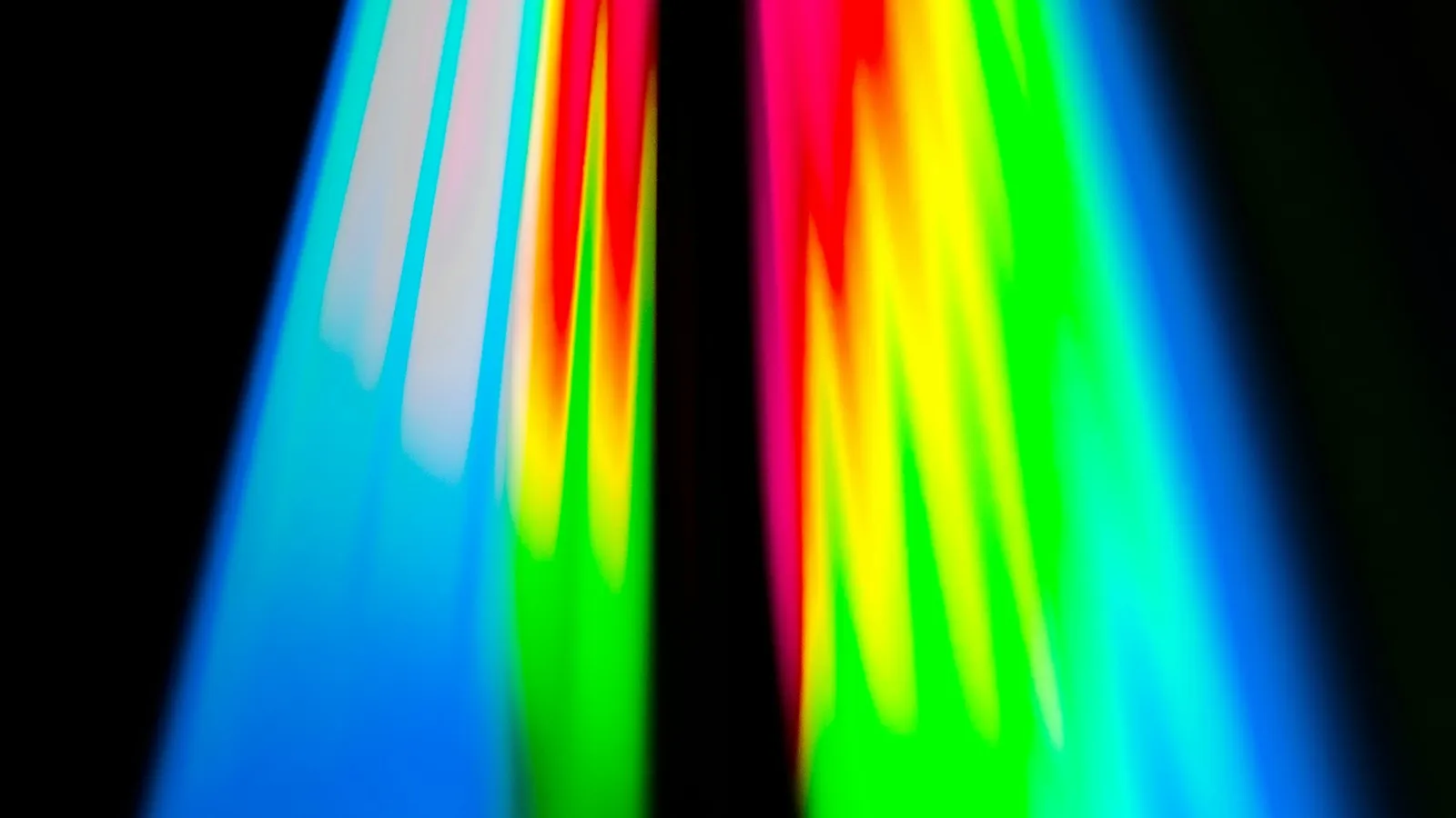 Vertical bands of red, green and blue light against a dark background