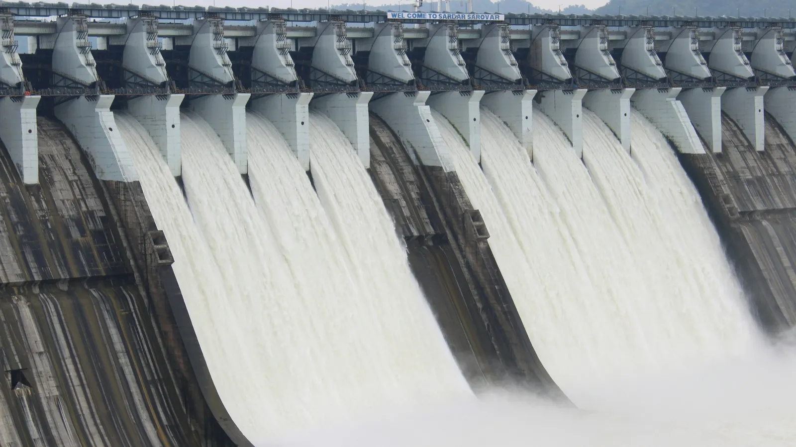 Water rushing through the open gates of a dam