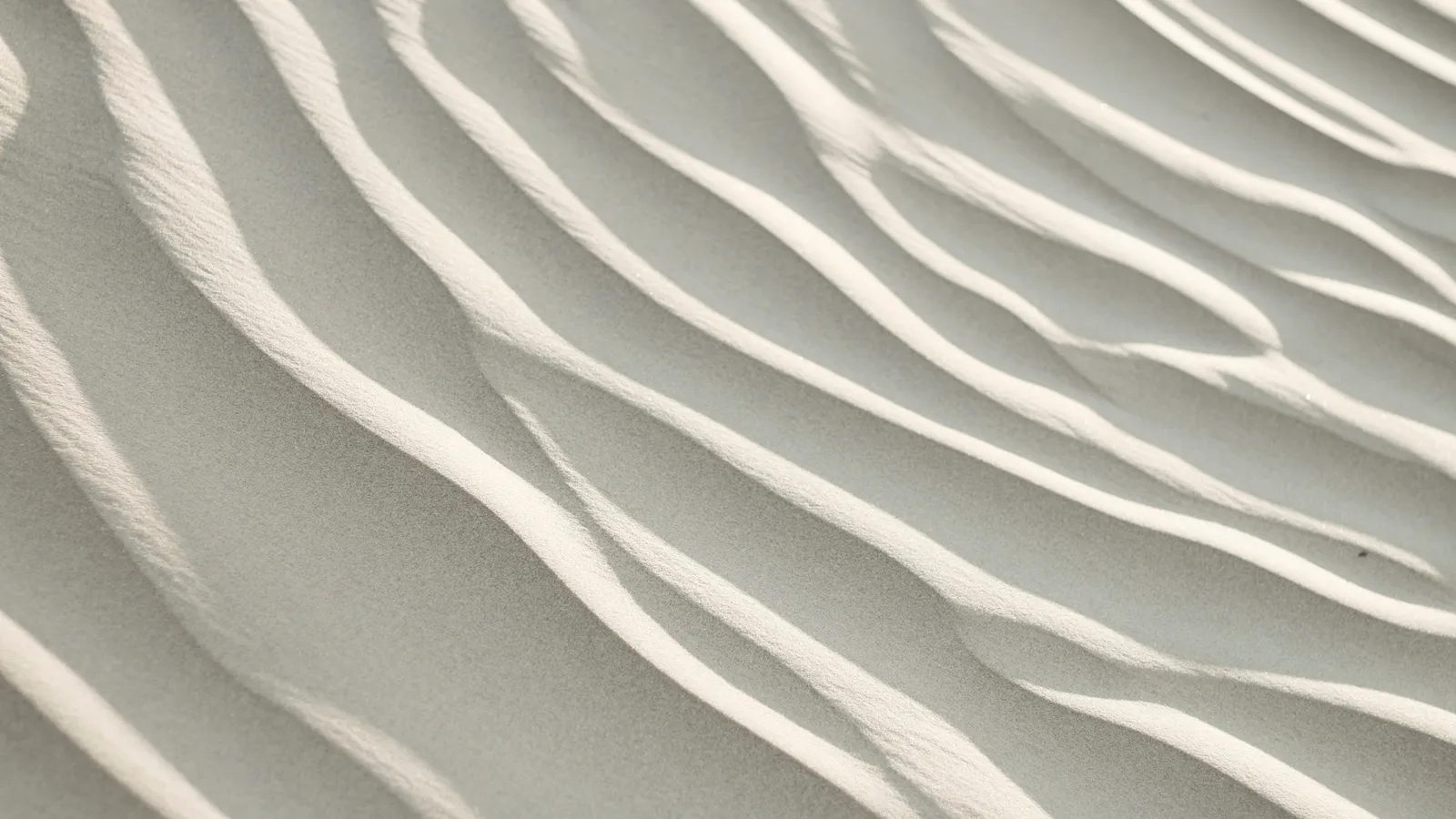 Wavy ripple patterns in pale sand