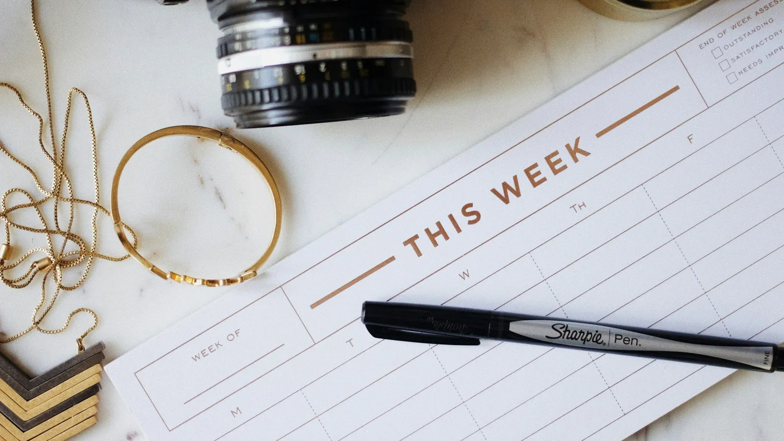 Weekly planner page titled This Week with a pen
