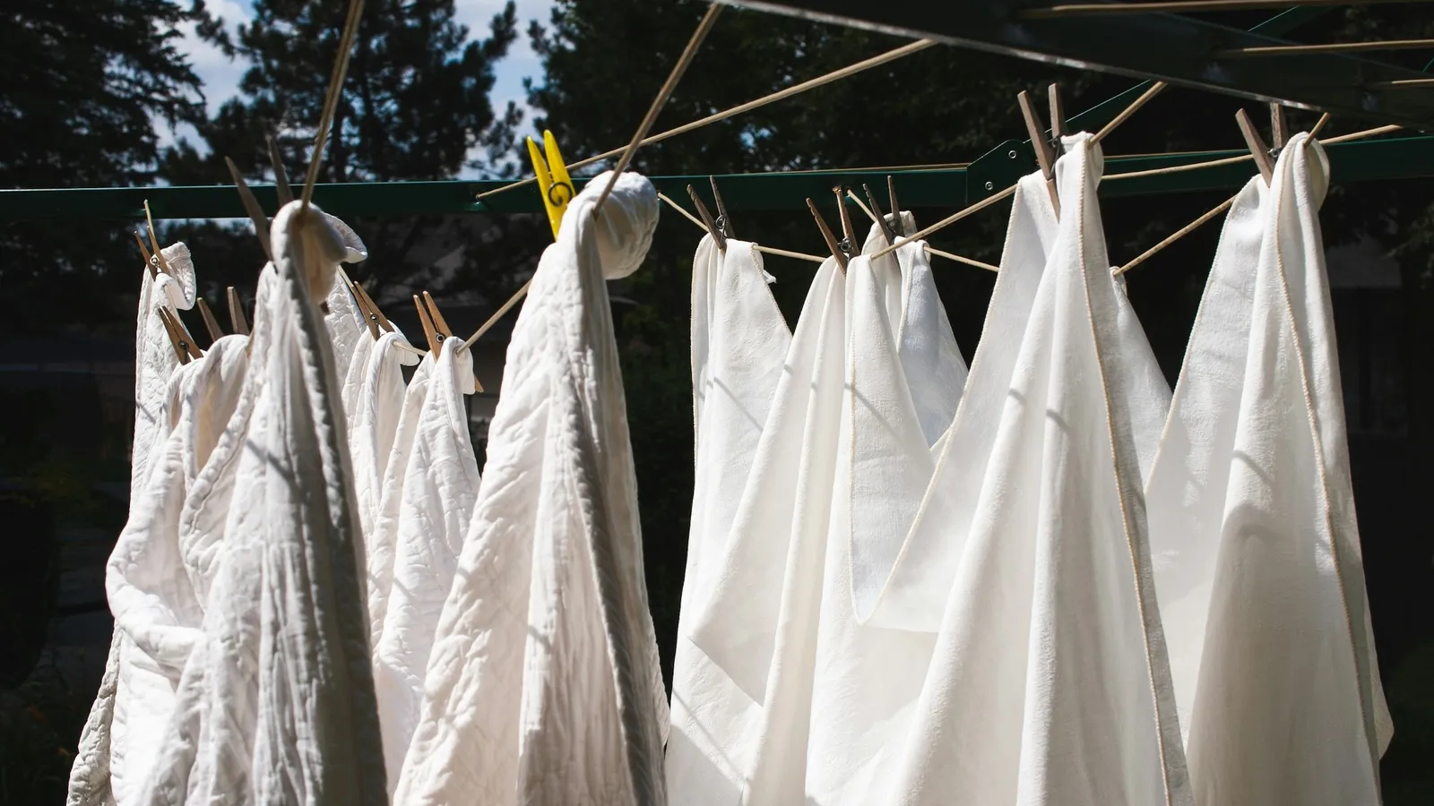 White linen shirts drying on a washing line