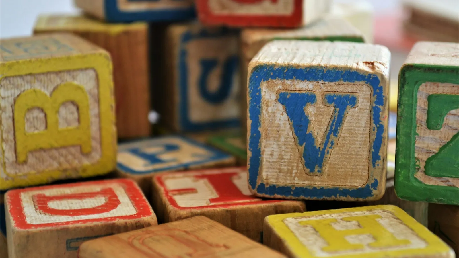 Wooden alphabet blocks piled together
