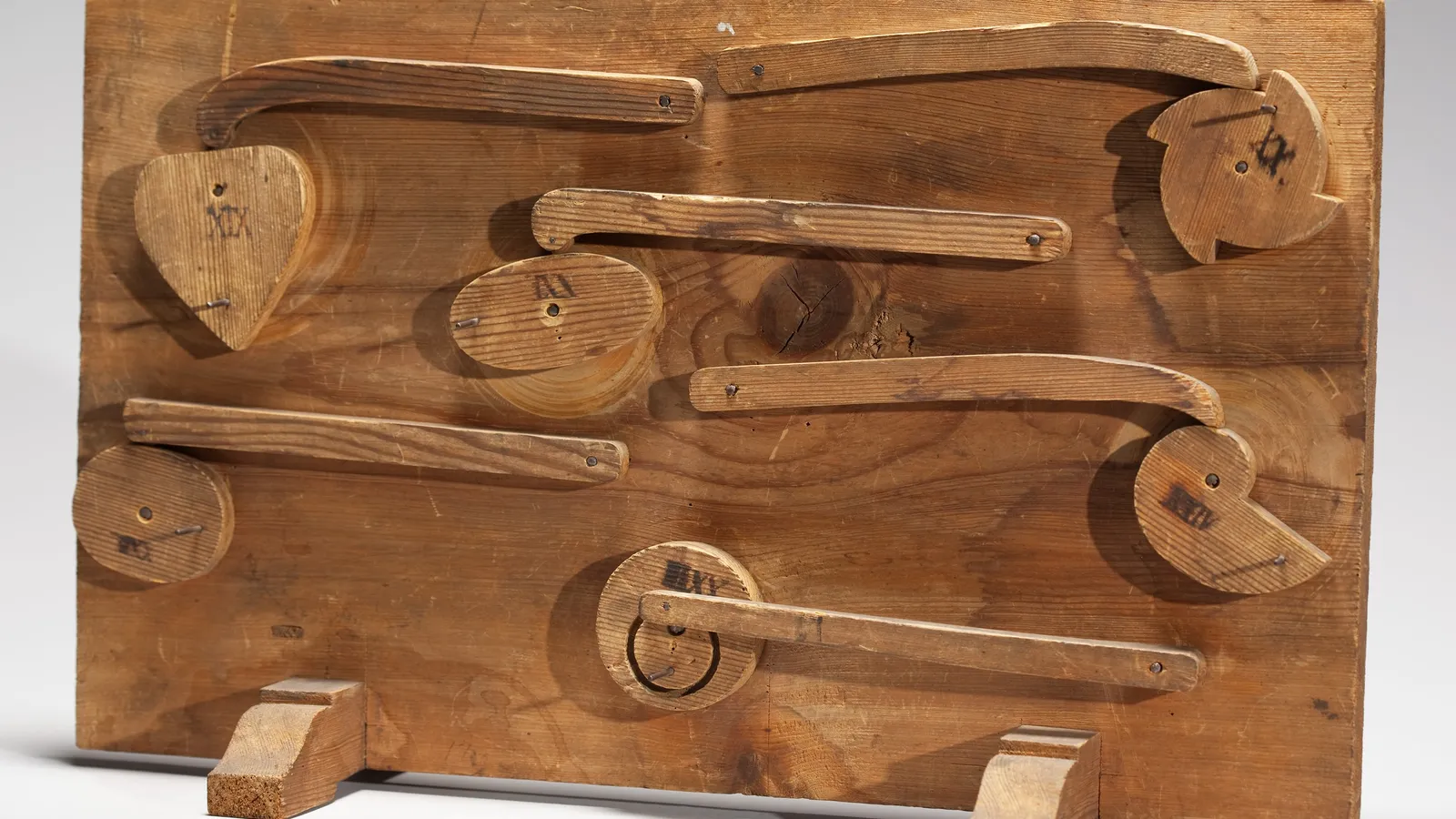 Wooden board with six cams, one heart-shaped, and levers from Polhem's mechanical alphabet