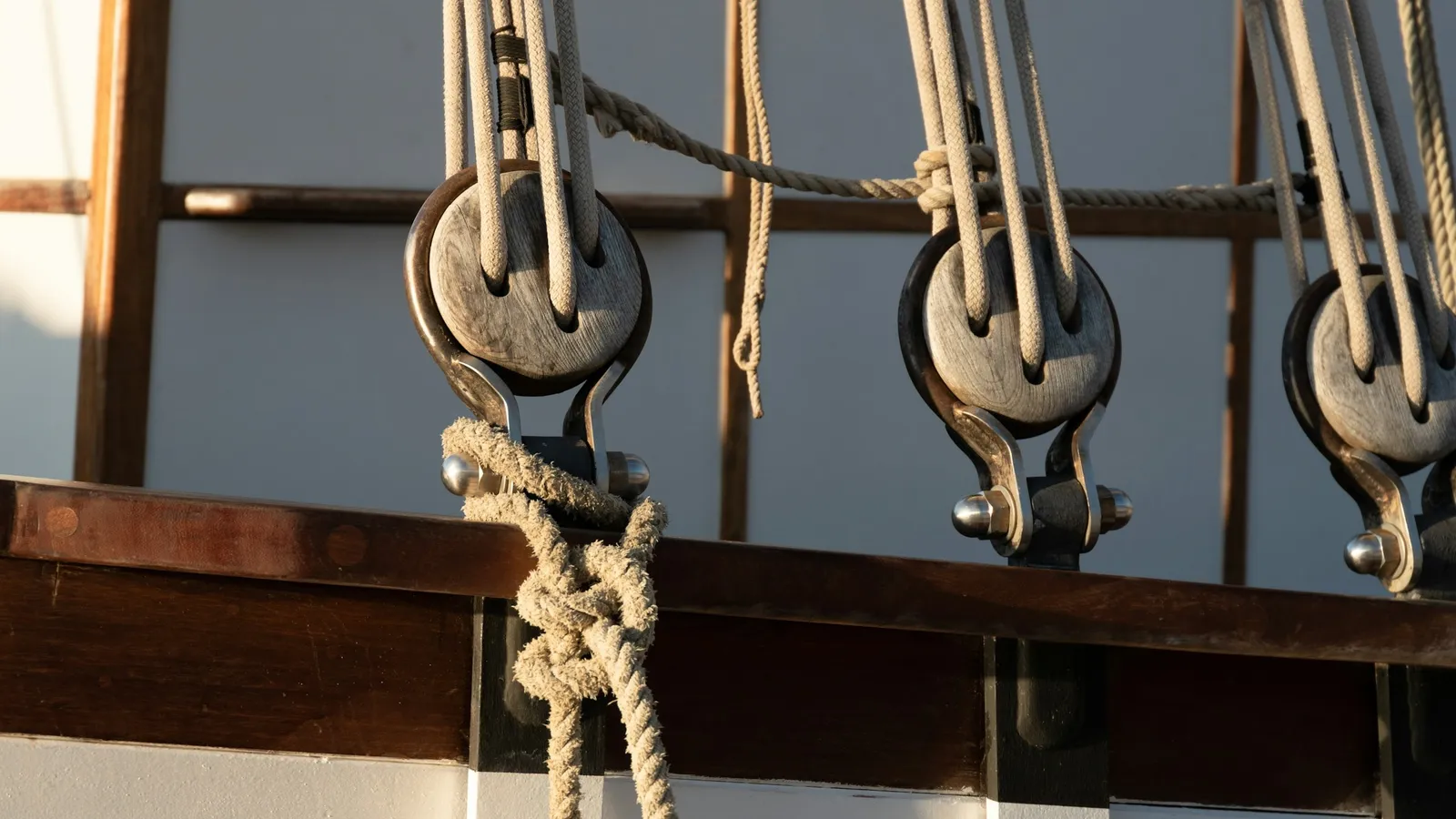 Wooden pulley blocks threaded with rope