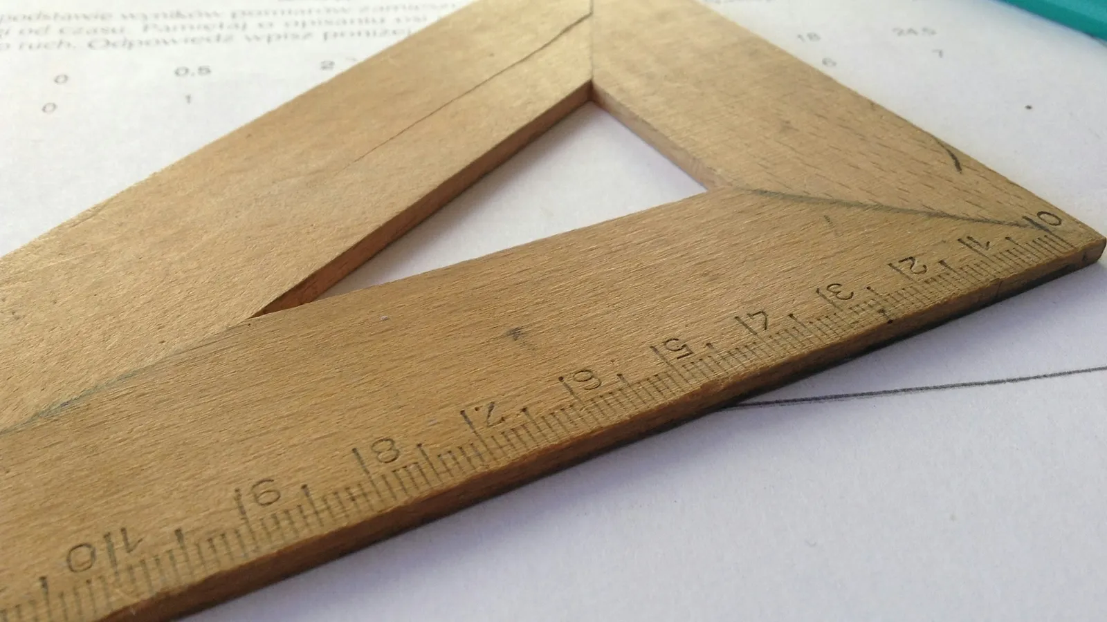 Wooden set square on paper
