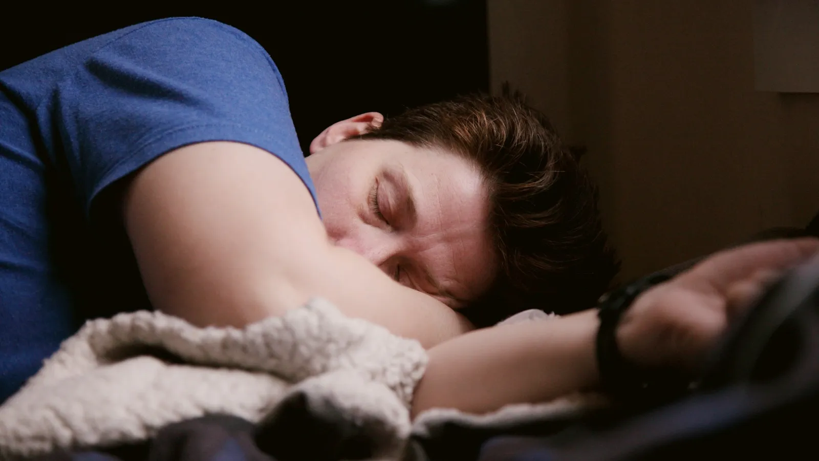 Young man asleep in bed