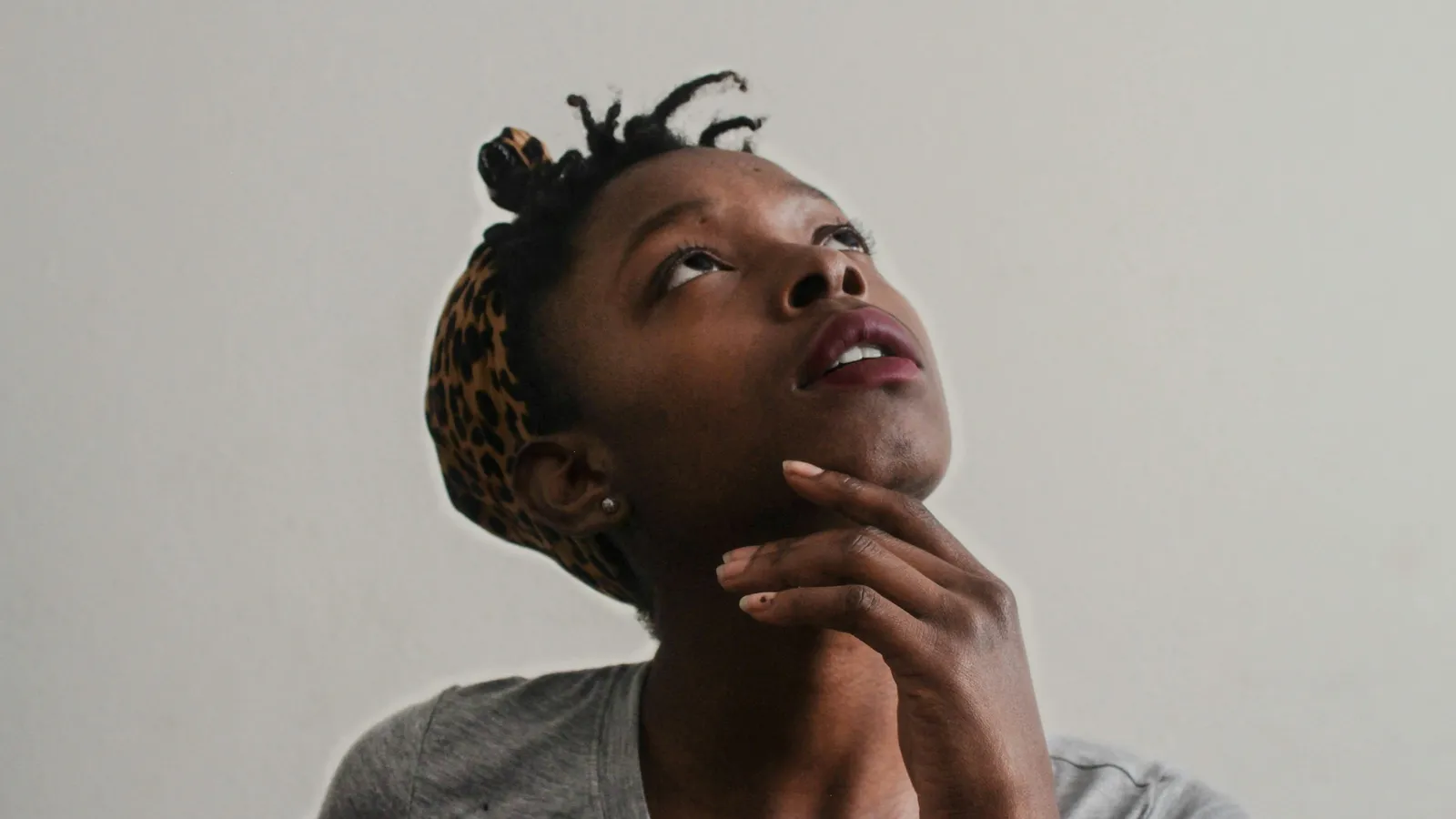 Young woman looking up while thinking
